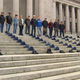 Anti-vax former Washington State Patrol troopers and other employees lay hats of their fired colleagues on the state Capitol in a protest against the state's employee vaccination requirement.